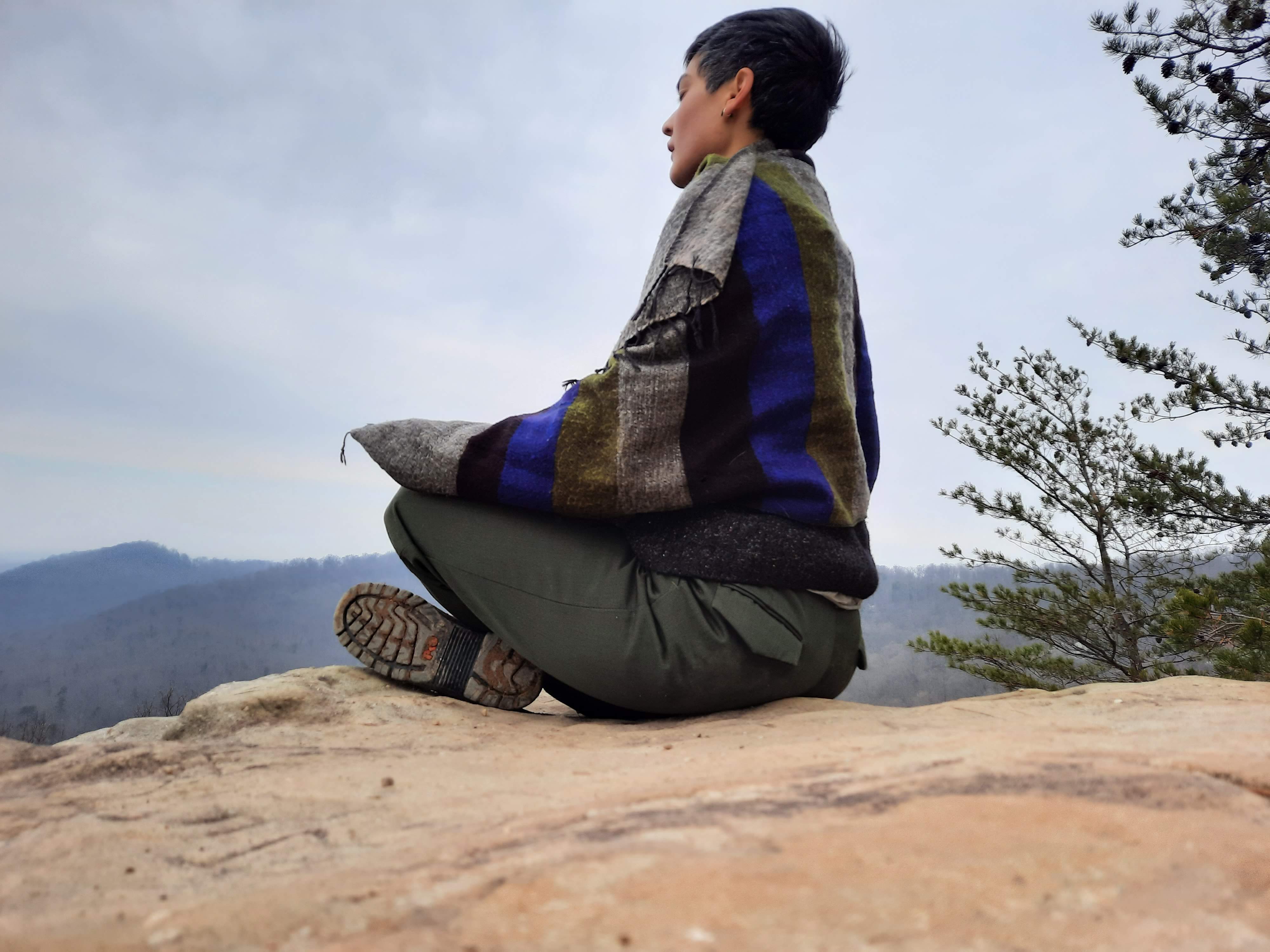 Woman meditating on a rock